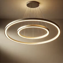 DALL·E 2025-01-07 13.47.14 - A modern LED chandelier featuring two to three interlocking circular rings of varying sizes. One large circle dominates the design, with one medium an